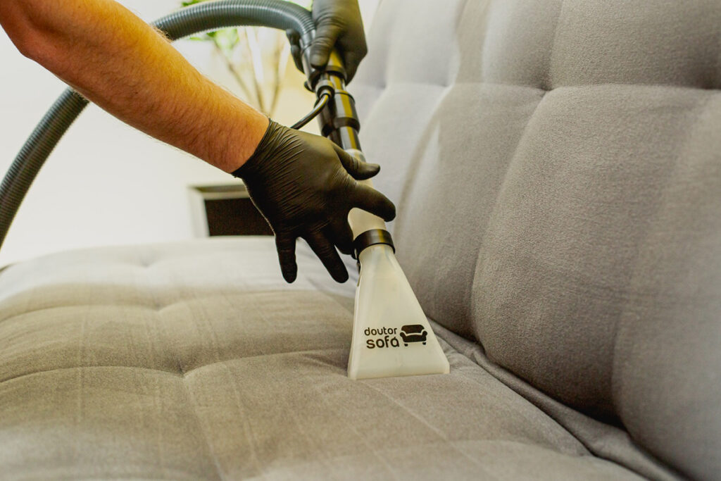 Extraction tool with the Doctor Couch logo running over the seat of a gray sofa.